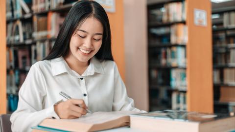 A student in the library busy studying the subjects needed for law
